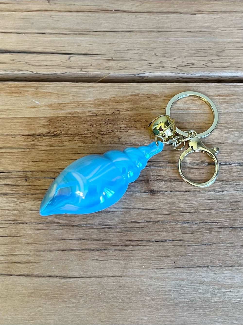 Bright blue conch shell-shaped bag charm/keychain